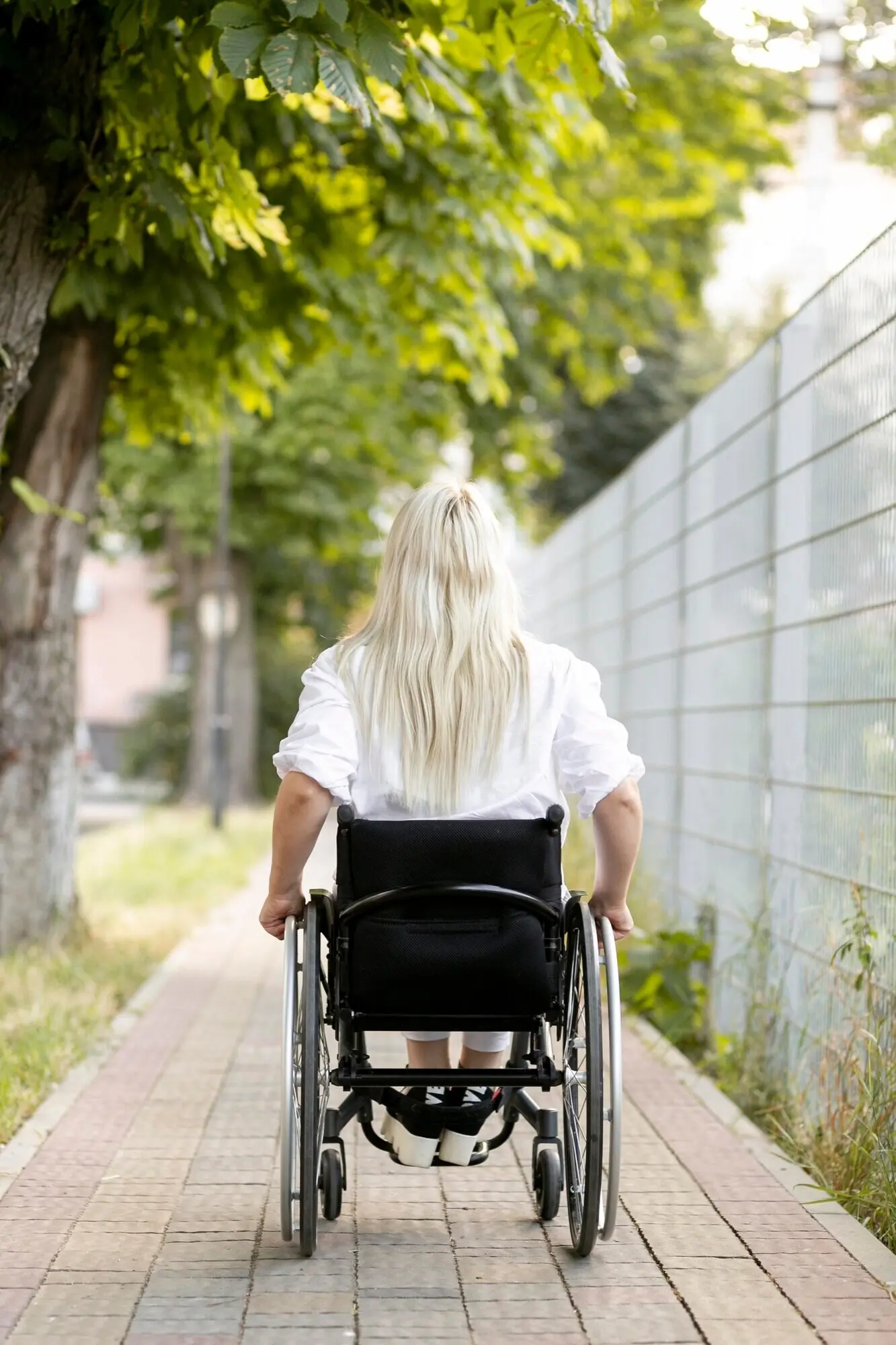 Rear view of a woman in a wheelchair in the city