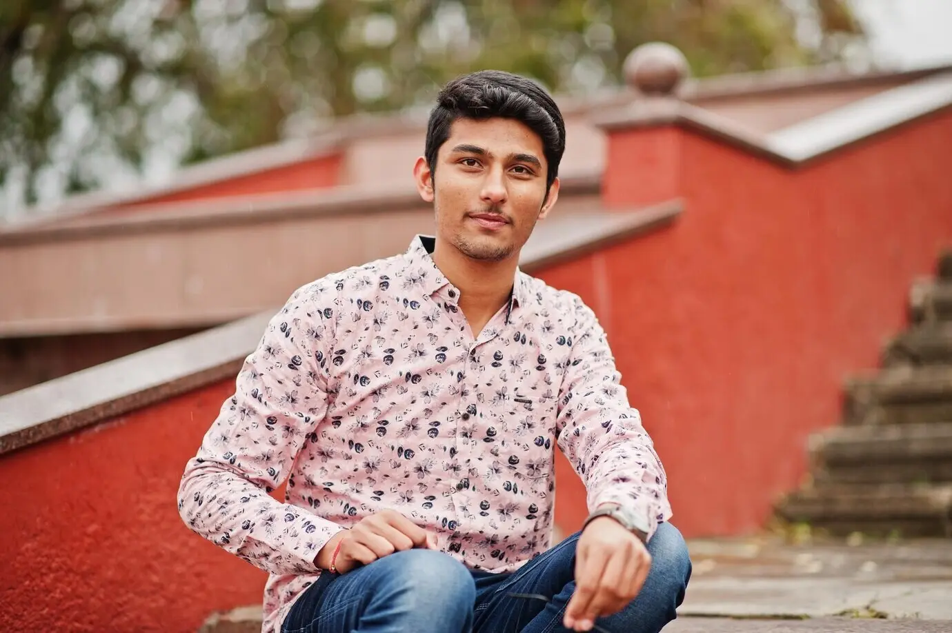 An Indian male student, wearing a shirt, posed outdoors.